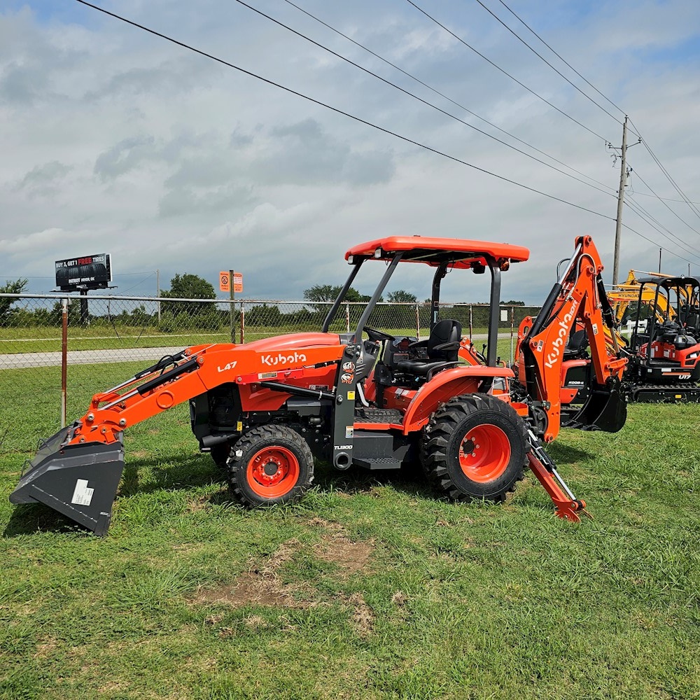 Kubota L47 parked in grass out front of a Kubota Center location